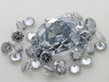 A fancy blue cushion shape diamond, weighing 2,04 ct surrounded by small blue brilliants