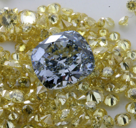 The same fancy blue cushion shape diamond, surrounded by intense yellow brilliants