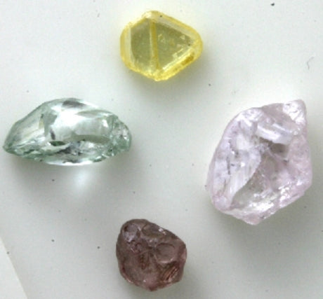 Four rough diamonds, all different colours